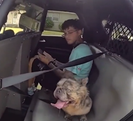 Kody with his owner Waldemar Gonzalez inside the police cruiser
